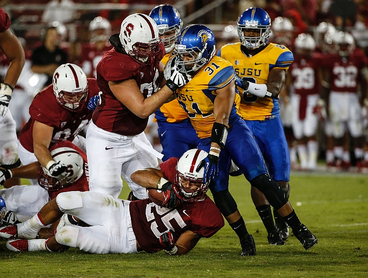 130907-Stanford-SanJose-014.JPG - Sept.7, 2013; Stanford, CA, USA; Stanford Cardinal running back Tyler Gaffney (25) is tackled by Keith Smith (31) after a 5 yard run against the San Jose State Spartans at  Stanford Stadium. Stanford defeated San Jose State 34-13.